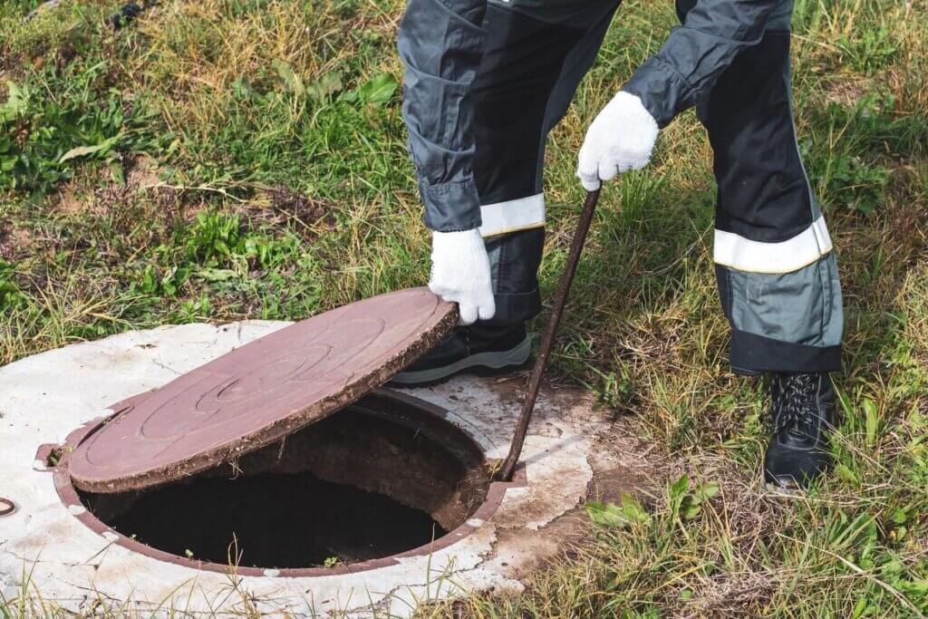 septic sewer well worker opens manhole cover plumbing work 326821 6264 septic sewer well worker opens manhole cover plumbing work 326821 6264