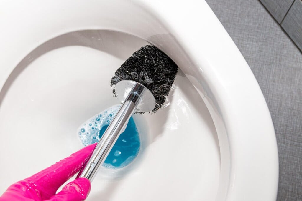 woman hand with pink rubber gloves is cleaning toilet bowl by using toilet brush 247934 139 woman hand with pink rubber gloves is cleaning toilet bowl by using toilet brush 247934 139