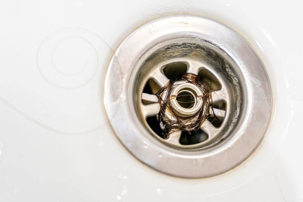 closeup long hair blocking drain bathroom 585982 3079